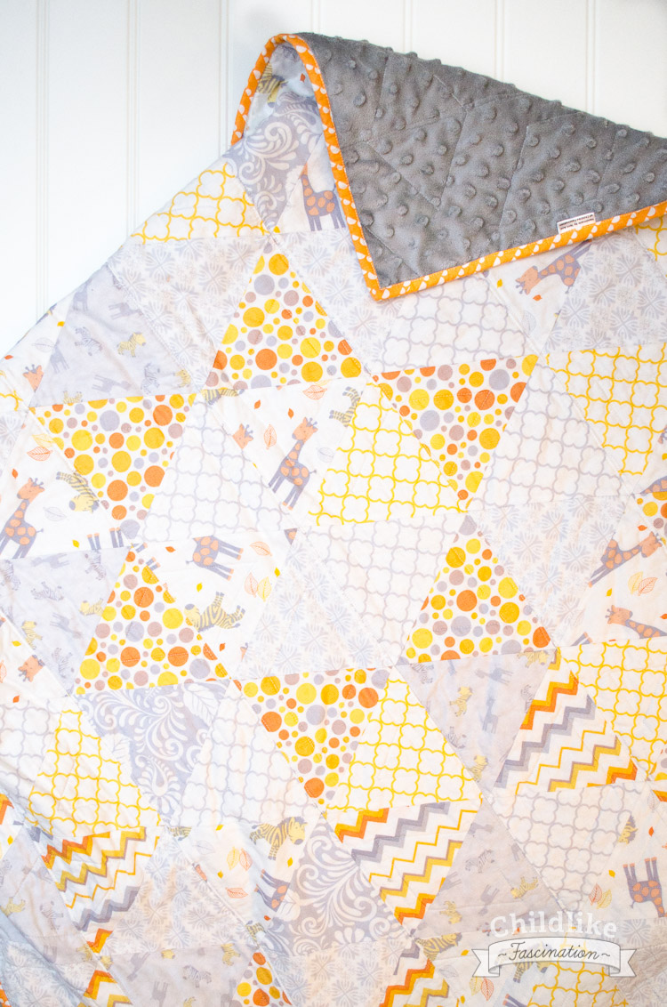 Love the way the triangles for a 6 pointed star on this Triangle Baby Quilt